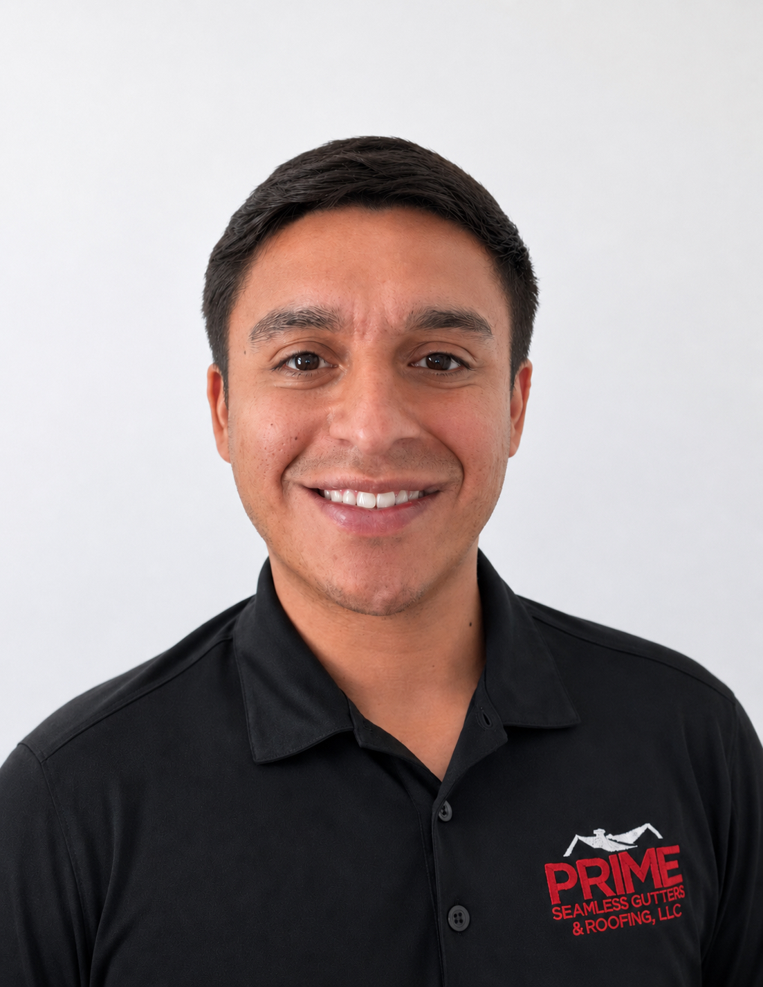 Smiling man in black Prime Seamless Gutters & Roofing polo shirt against white background, professional headshot for San Antonio roofing and gutter contractor