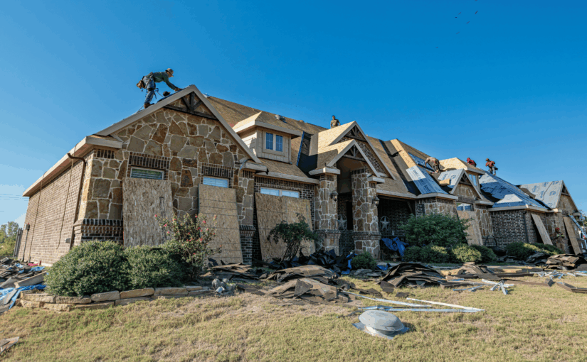 Roofers installing new roof on brick home during active roof replacement project in San Antonio, Texas